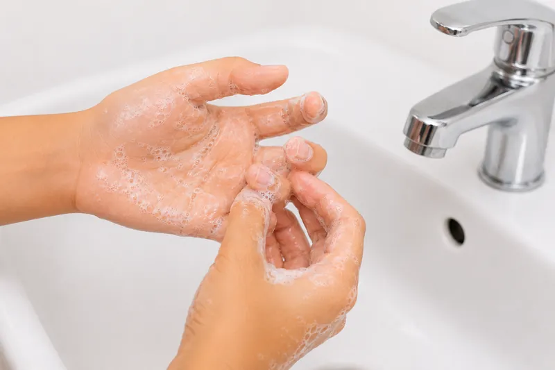 Cleaning under the fingernails.